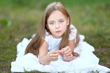 Naklejka na ściany i meble portrait of little girl outdoors in summer