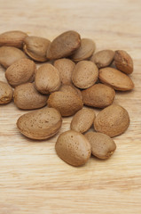 Some almonds in wooden background