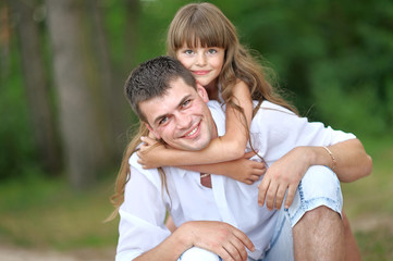 portrait of a happy family in summer nature