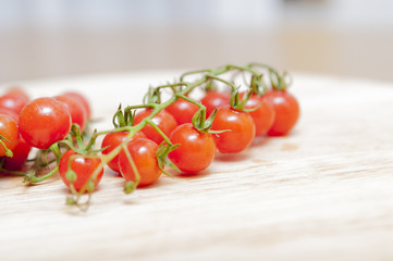 Some red cherry tomatoes in wooden background