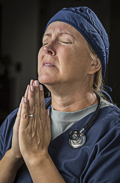 Pleading in Prayer Female Doctor or Nurse