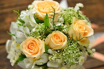 Beautiful bouquet of flowers on wooden background