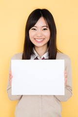 Naklejka premium young asian woman on yellow background