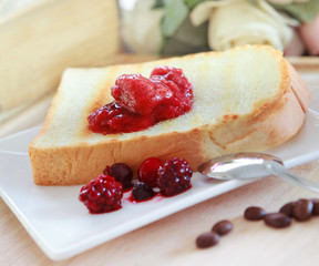 toast bread and strawberry jam on white plate