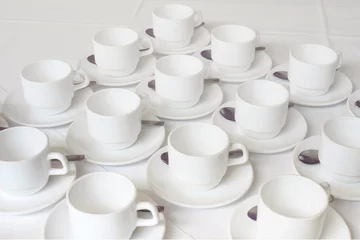 Gartenposter Group of white coffee cups in cafe bar © Canvas Alchemy