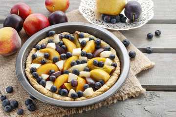 Tart with peach, pumpkin, plum, pear and blueberry