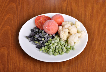 frozen tomato, asparagus, peas and cauliflower on a plate