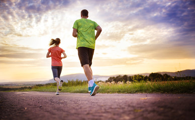 Couple running at sunset