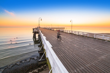 Fototapeta premium Sunrise at wooden pier in Sopot over Baltic sea, Poland
