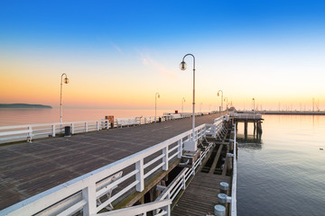 Fototapeta premium Sunrise at wooden pier in Sopot over Baltic sea, Poland