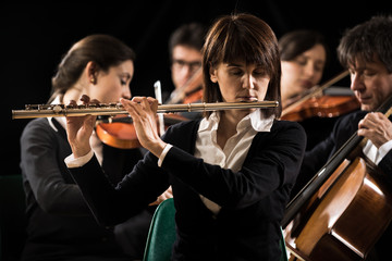 Symphony orchestra performance: flutist close-up © stokkete