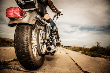 Fototapeta Biker girl riding on a motorcycle obraz