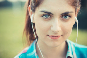 beautiful young hipster woman listening music