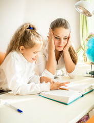 confused mother looking at daughters homework