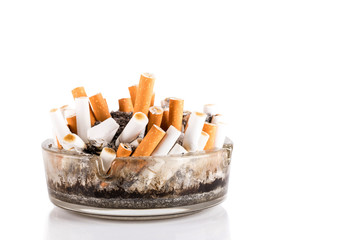 A dirty ashtray with cigarette ash and butts