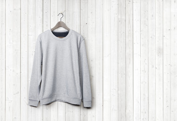 Sweater on a white wood wall