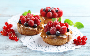 Sweet cakes with berries on table close-up