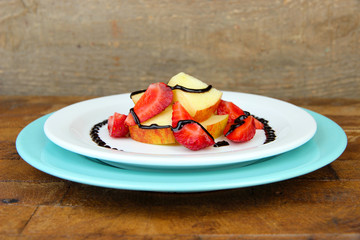 fresh tasty fruit salad on wooden table