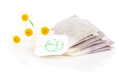 bags of chamomile tea with fresh camomile flower, isolated on wh