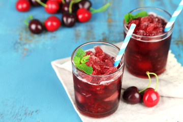 Closeup of cherry granita in glasses, on color wooden