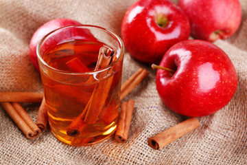 Apple cider with cinnamon sticks and fresh apples