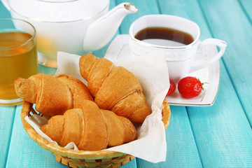 Breakfast with tea, apple juice, jam and fresh croissants