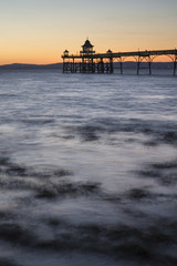 Fototapeta na wymiar Long exposure landscape image of pier at sunset in Summer