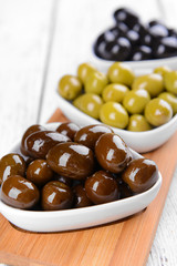 Different marinated olives on table close-up
