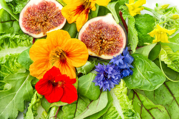 fresh green salad with flowers and fig fruits. healthy food