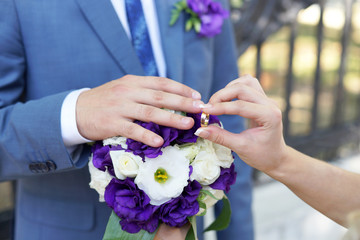 bride and groom exchange wedding rings