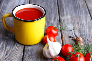 Homemade tomato juice in color mug, spices and fresh tomatoes