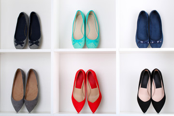 Colorful female shoes on wooden shelves