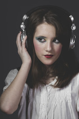 Fototapeta premium Mp3, young girl listening music with huge headphones