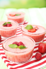 Delicious berry mousse in bowls on table close-up