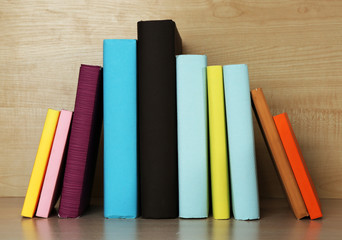 Fototapeta na wymiar Books on wooden shelf close-up
