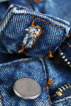 Zipper and button on clothes close up