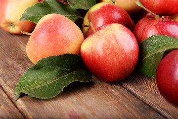 Ripe red apples on wooden background