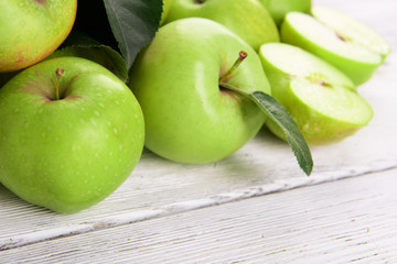 Ripe green apples on wooden background