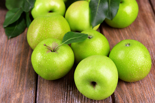 Ripe green apples on wooden background