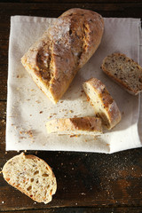 Sliced white bread on white napkin on wooden background