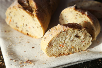 Sliced white bread on white napkin on wooden background