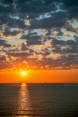 Naklejka na ściany i meble Colored sunrise over the sea.