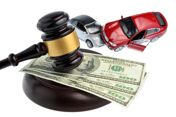 Hammer of judge with money and toy cars isolated on white