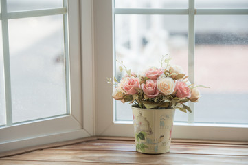 Artificial roses in the basket in vintage theme