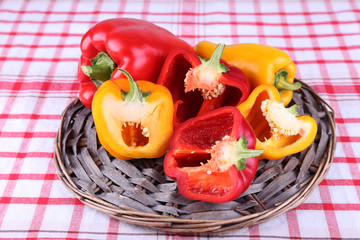 Pepper on wicker mat on fabric background
