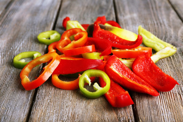 Sliced pepper on wooden background