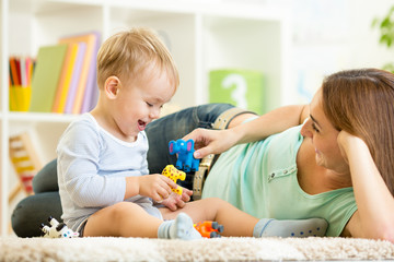 kid and mom playing with toy animals indoors © Oksana Kuzmina