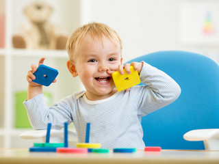 little child playing with building blocks © Oksana Kuzmina