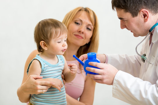 doctor counseling mother and kid about nasal irrigation or douch
