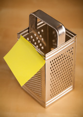 Empty post-it note sticked on grater